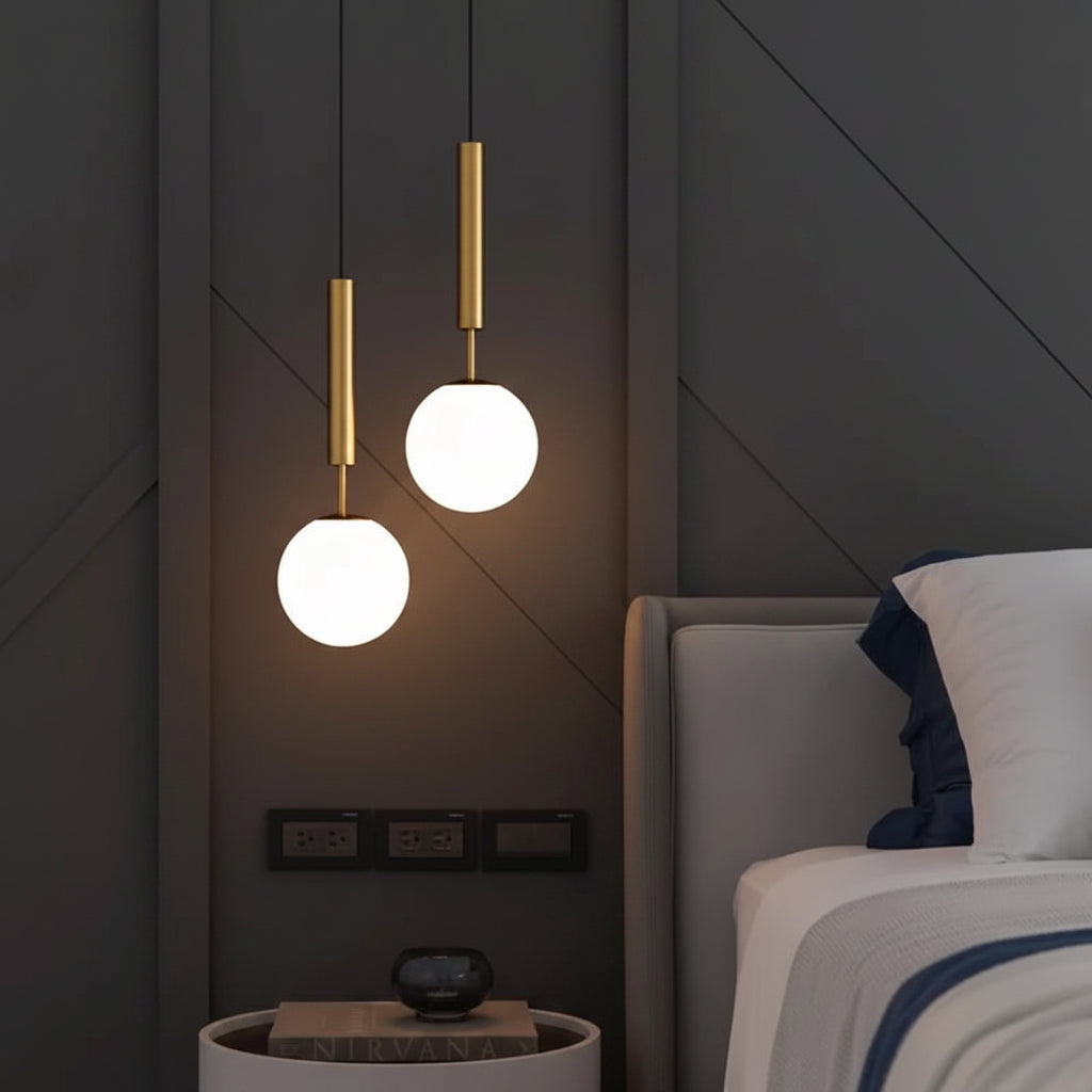 Gold globe pendant light with two cylinder stems and two round white glass shades