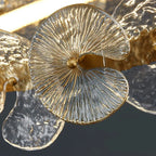 Close-up of gold-tone petal disc chandelier with textured glass disc shade