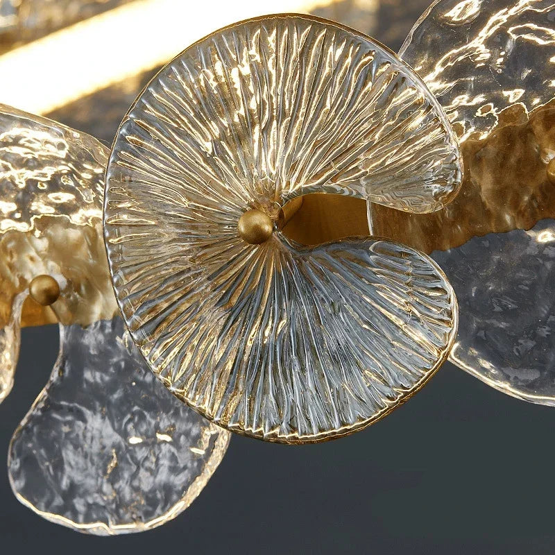 Close-up of gold-tone petal disc chandelier with textured glass disc shade