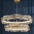 Gold-tone hanging chandelier with layered petal discs and circular ribbed ring shade