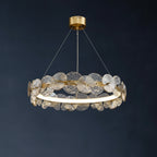 Gold-tone circular ribbed chandelier with layered petal disc elements and glowing ring