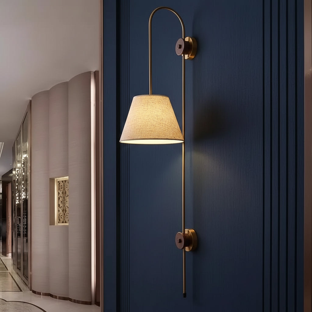 Swan-neck wall light with fabric shade, tall brass frame, and two round mounts