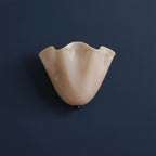 Cream white scalloped wave glass wall light with dark mounting base