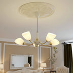 Angled cone chandelier with gold arms and multiple white cone shades