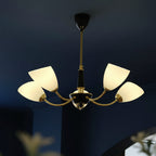 Angled cone chandelier with black canopy, gold arms, and five white cone shades