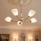 Angled cone chandelier with gold arms and five white angled cone shades