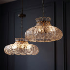 Glass petal scalloped hanging chandelier with ripple texture, warm amber glow.