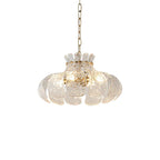 Ripple-textured glass chandelier shade with scalloped petal design, suspended on chain.