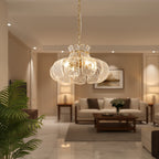Ripple scalloped glass chandelier hanging from a chain, warm lit petal shades.