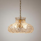 Close view of ripple-textured glass petal chandelier shade with scalloped edge detail.