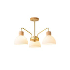 3-light branch chandelier with ribbed white glass shades, gold frame, and light wood caps