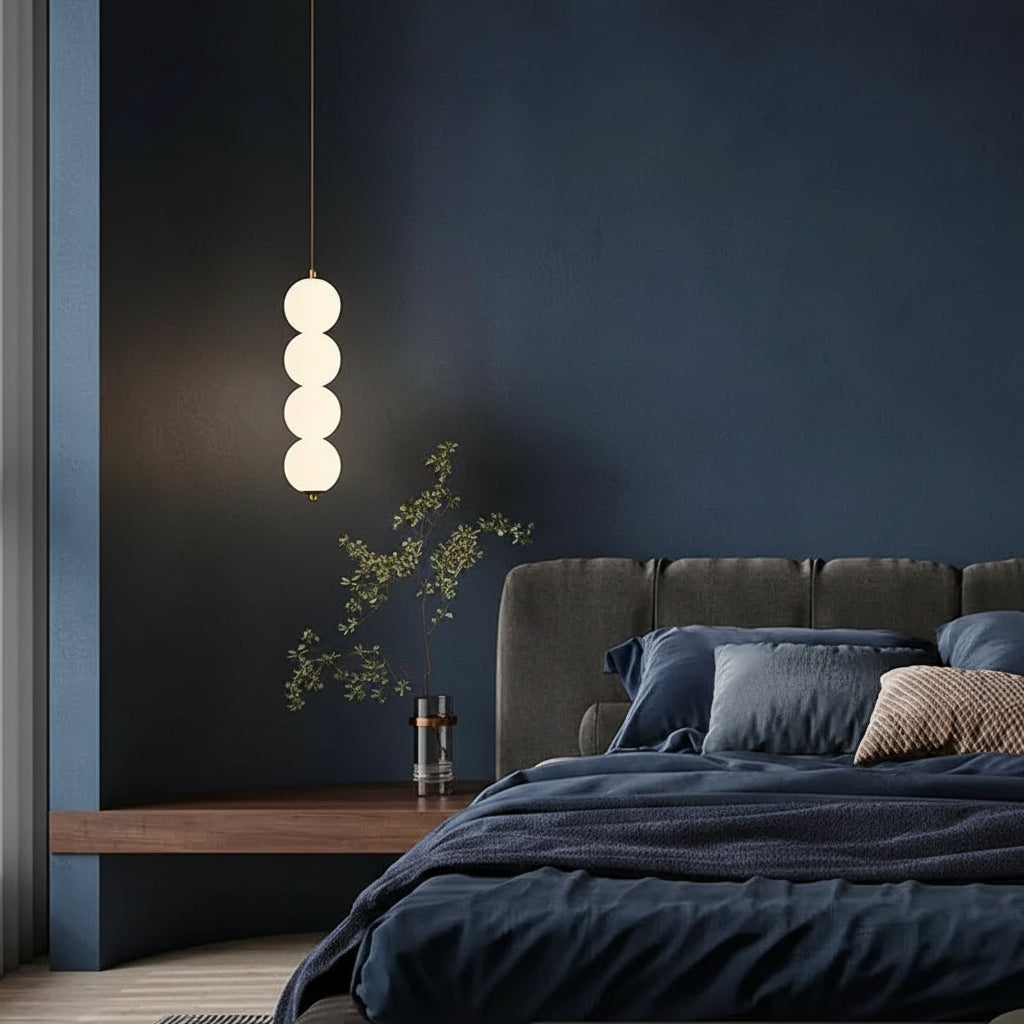 Stacked globe pendant light with four opal glass shades, black cord