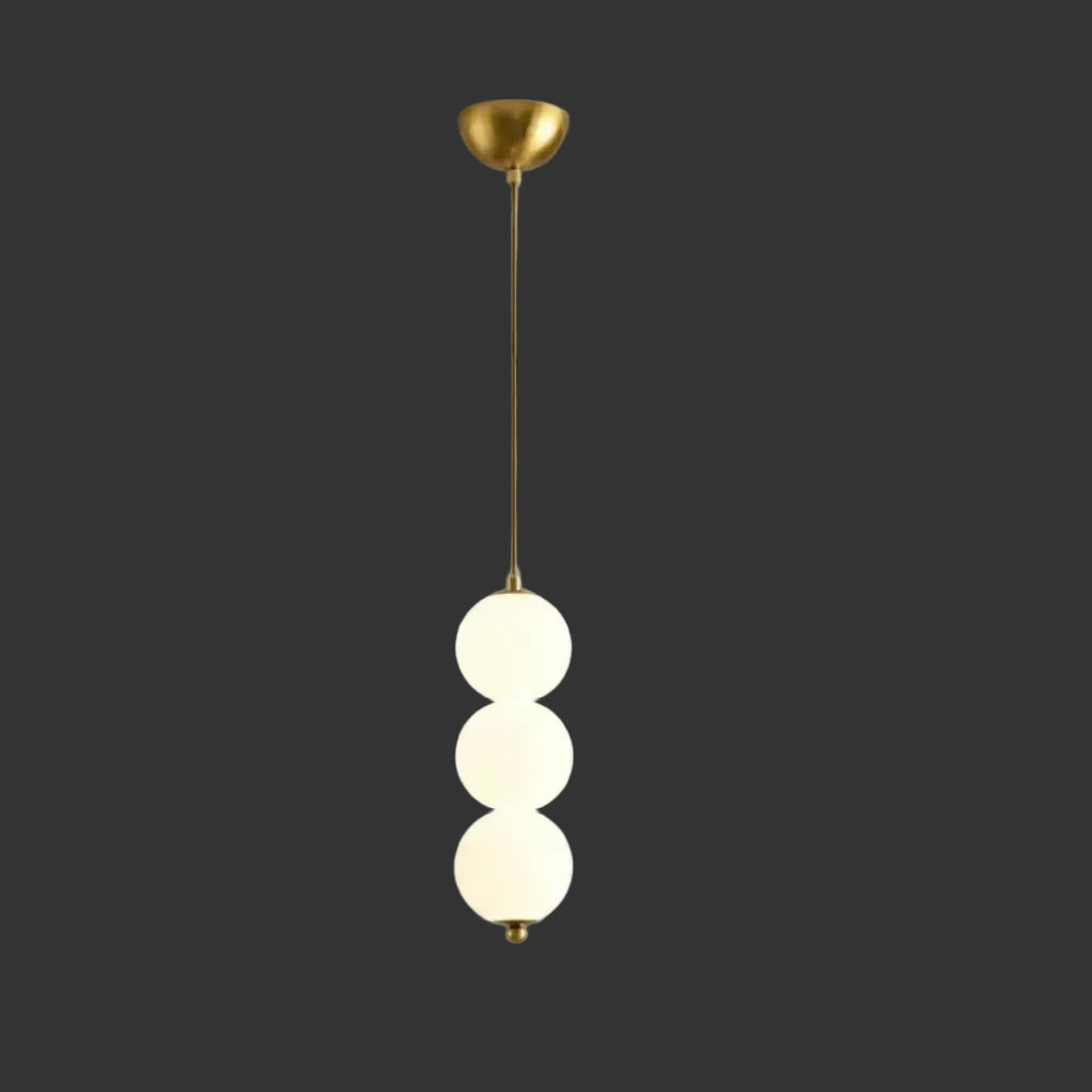 Stacked globe pendant light with three opal glass shades, gold stem and canopy