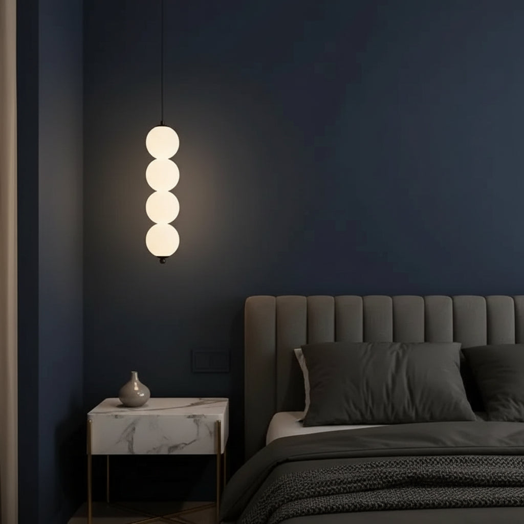 Stacked globe pendant light with four opal glass shades, dark cord