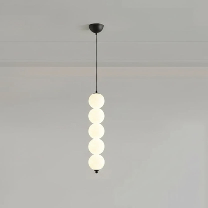 Stacked globe pendant light with five opal glass shades, dark canopy