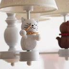Cat figurine finial holding a fish-like piece on a hanging chandelier base
