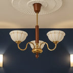 Gold 5-light chandelier with curved arms, ribbed petal canopy, off-white glass shades