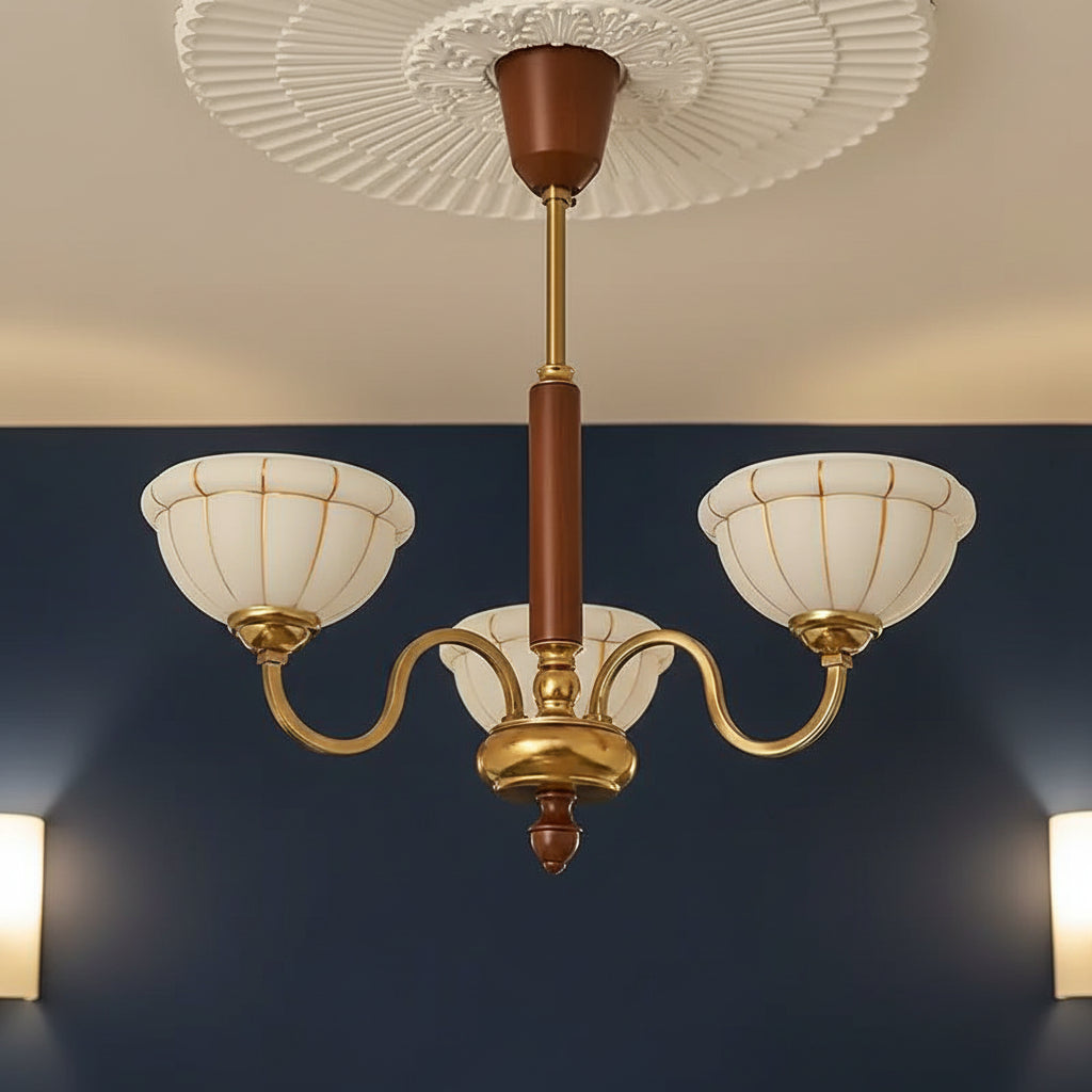 Gold 5-light chandelier with curved arms, ribbed petal canopy, off-white glass shades