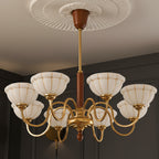 Gold 8-light chandelier with curved arms, off-white glass shades, ribbed petal canopy