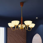 Gold multi-light chandelier with curved arms and off-white glass shades