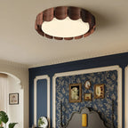 Round flush-mount ceiling light with scalloped wood panels around frosted diffuser