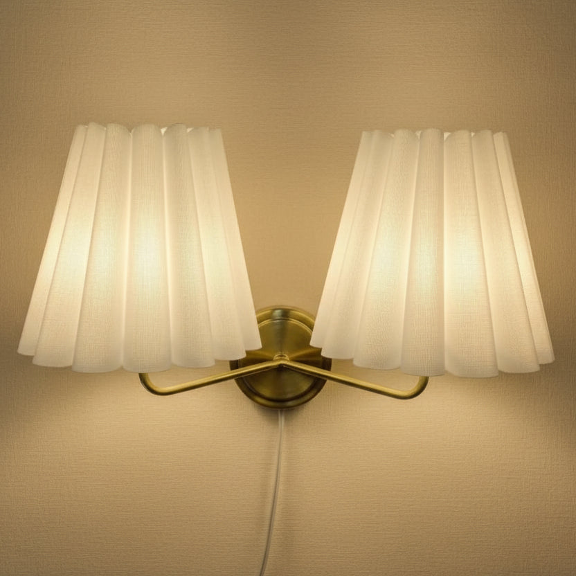 Double-head fabric wall lamp: two pleated cream shades, gold mount, corded plug