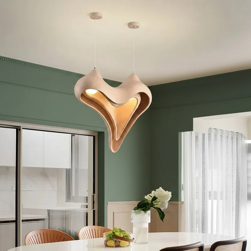 Layered heart conch pendant light with glowing warm interior, white outer shell