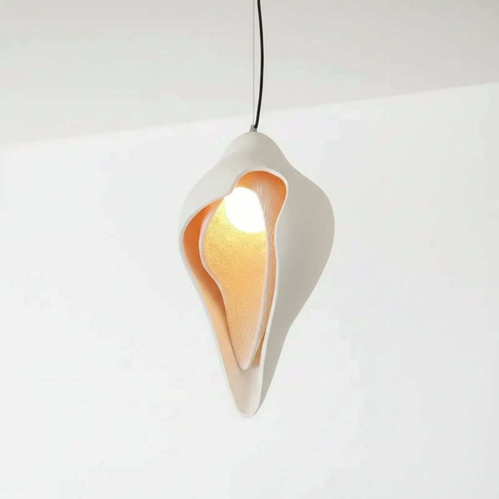 Conch shell pendant light with white shell and warm inner light, hanging on cord
