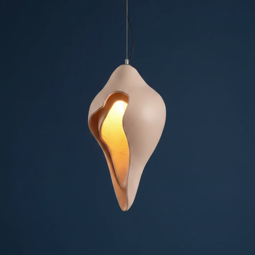 Conch shell pendant light in white with glowing gold interior, centered on cord