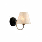 Black conical capiz shell wall sconce with curved arm and off-white shade