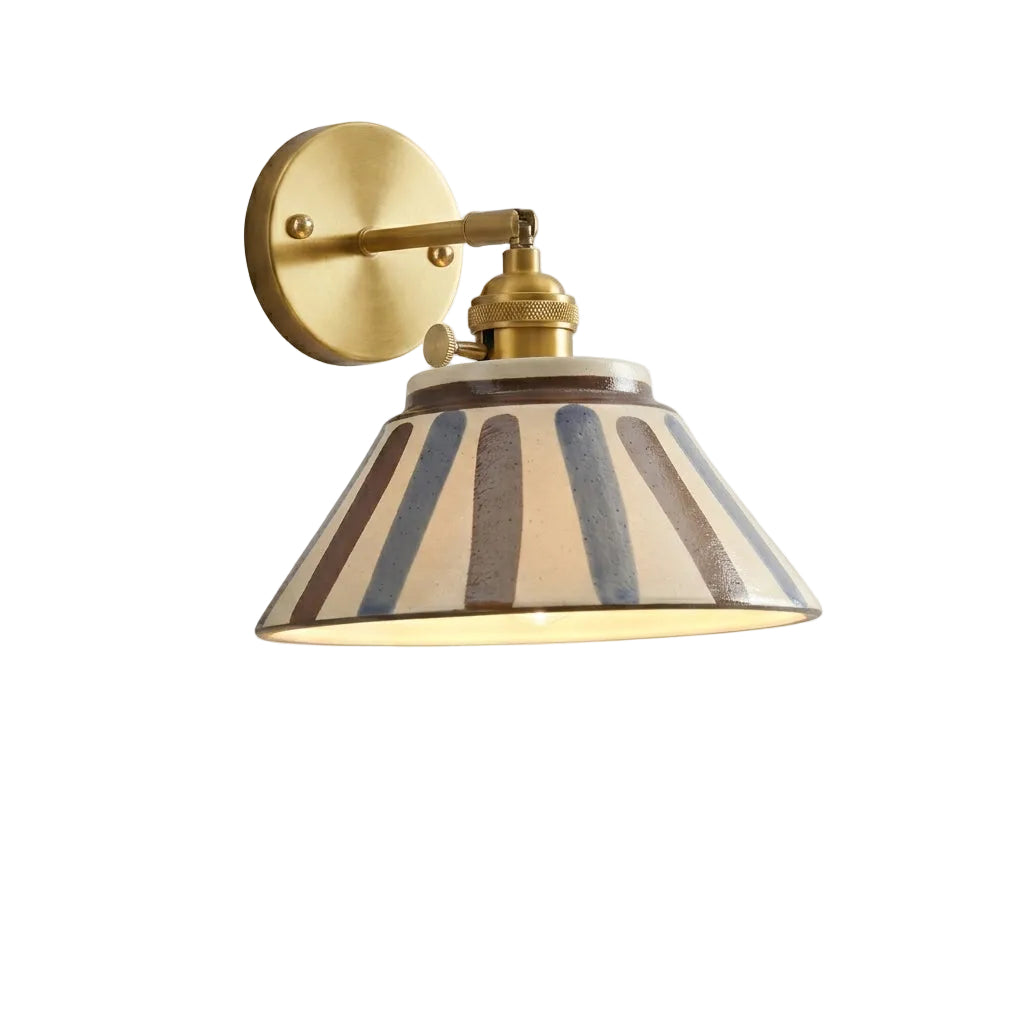 Brass wall sconce with round backplate and ceramic shade with vertical brown and gray stripes