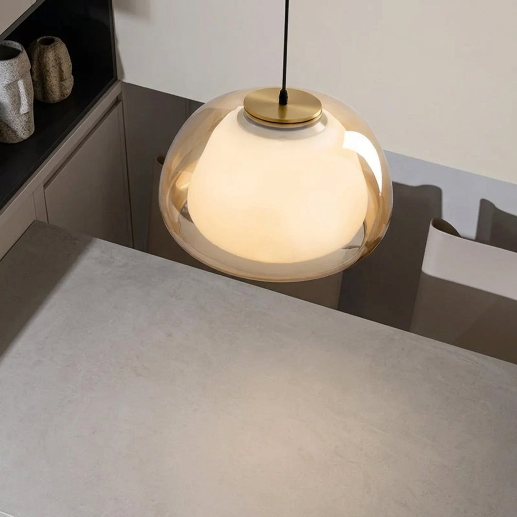 Nordic tinted glass pendant light with amber tinted glass dome and warm light