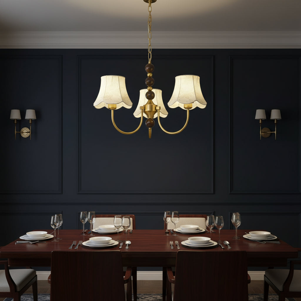 Gold multi-arm chandelier with cream scalloped shades and central hanging chain