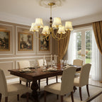 Multi-arm gold chandelier with chain beads and cream scalloped lampshades