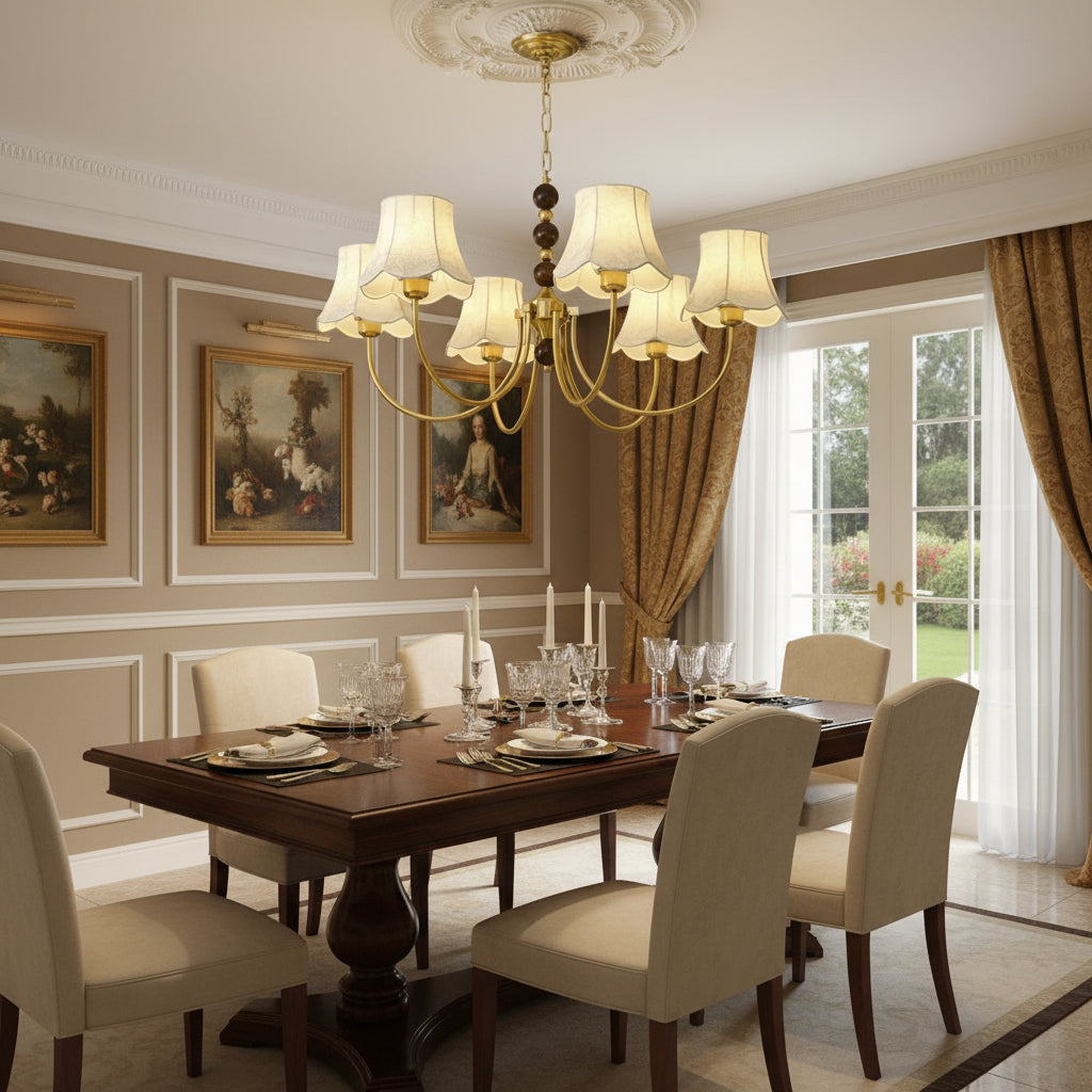 Multi-arm gold chandelier with chain beads and cream scalloped lampshades