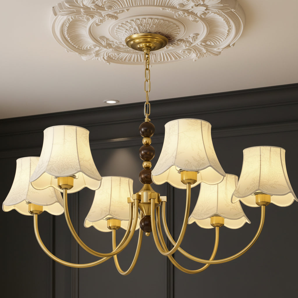 Gold multi-arm chandelier with bead chain and cream scalloped fabric shades