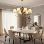 Gold chandelier with hanging chain beads and cream scalloped lampshades