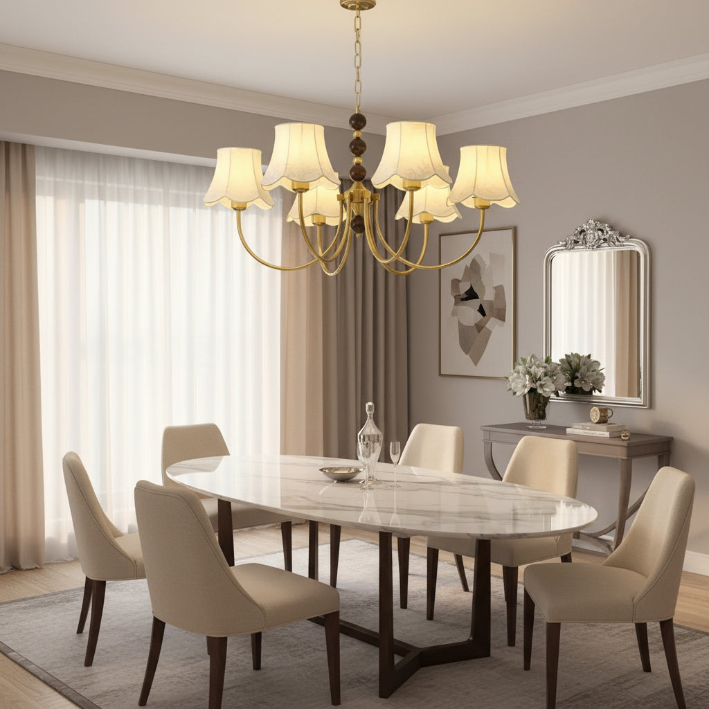 Gold chandelier with hanging chain beads and cream scalloped lampshades