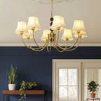 Gold multi-arm chandelier with bead chain and cream scalloped fabric shades