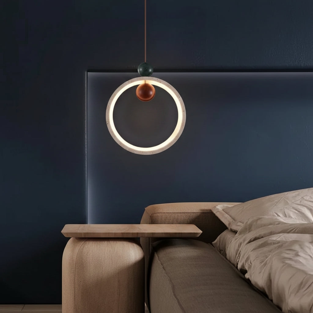 Circular halo pendant light with warm LED ring and bronze cap on dark cord