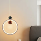Circular halo pendant light with speckled travertine ring and bronze inner bulb