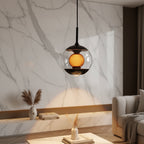 Hourglass globe pendant light: clear spherical glass shade with warm amber light inside