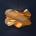 Light wood ribbon pendant lamp with overlapping curved shades and black hanging cord.