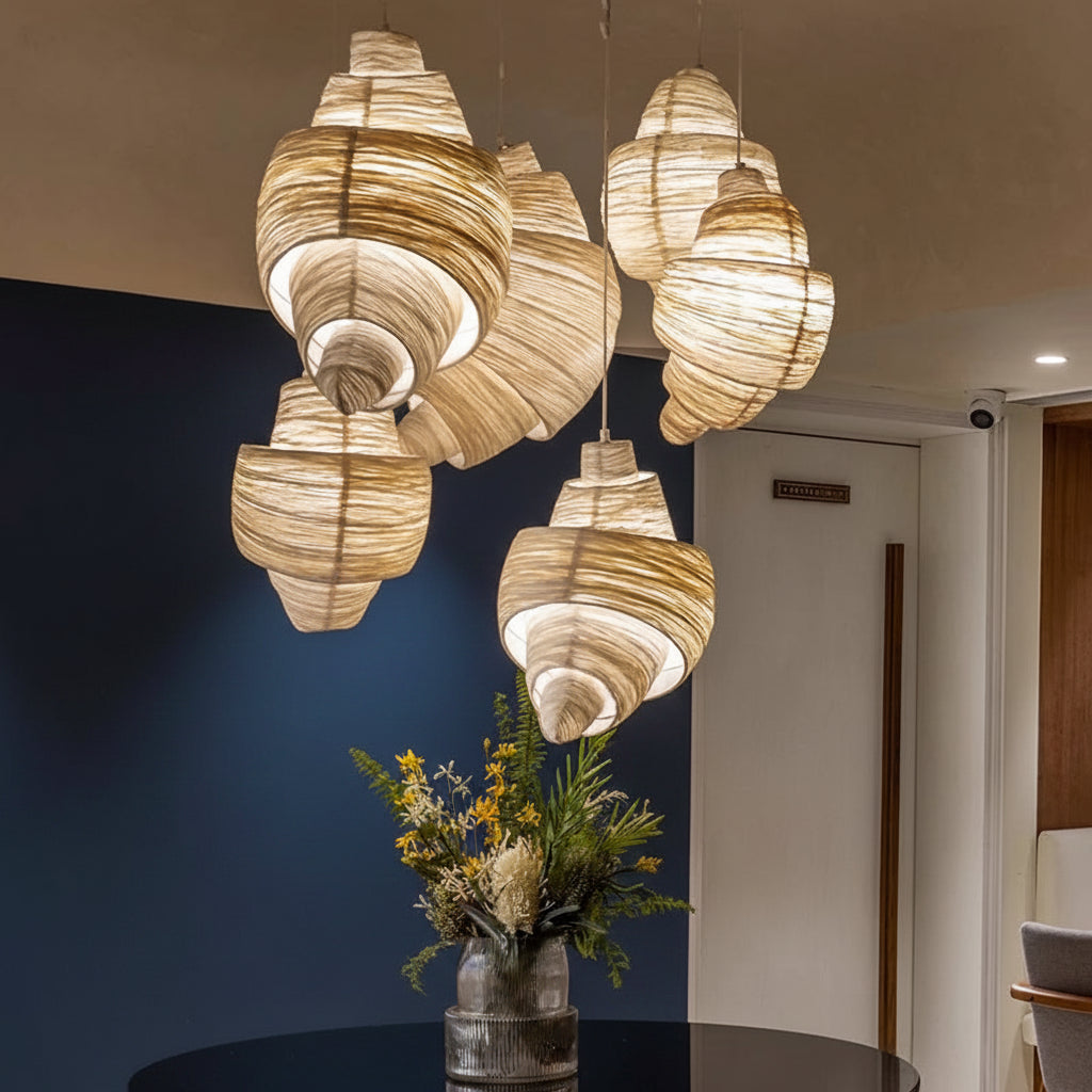 Cluster of brown woven layered pendant lights with curved horn-style shades