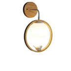 Halo bird wall light with lit globe, round wood backplate, and gold ring