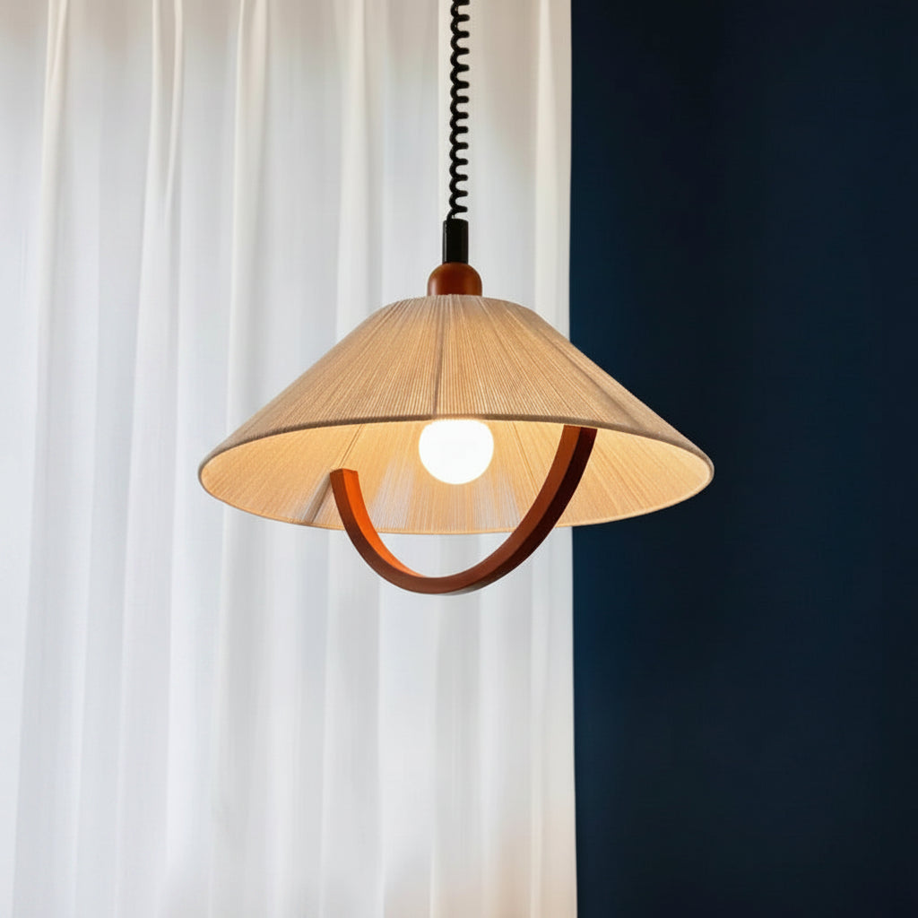 Cone-shaped fabric shade pendant light with curved wood trim and warm glowing bulb