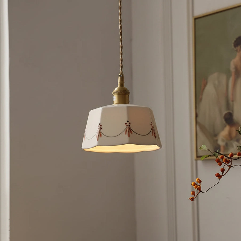 Tapered drum pendant light with white shade, floral accents, and brass cord