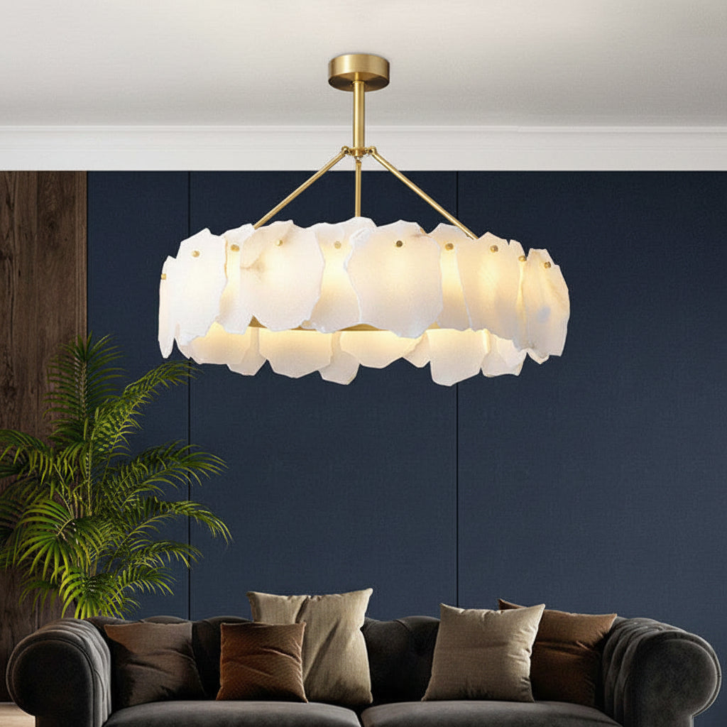 Brass tiered chandelier with white scalloped drum disc shades and hanging arms