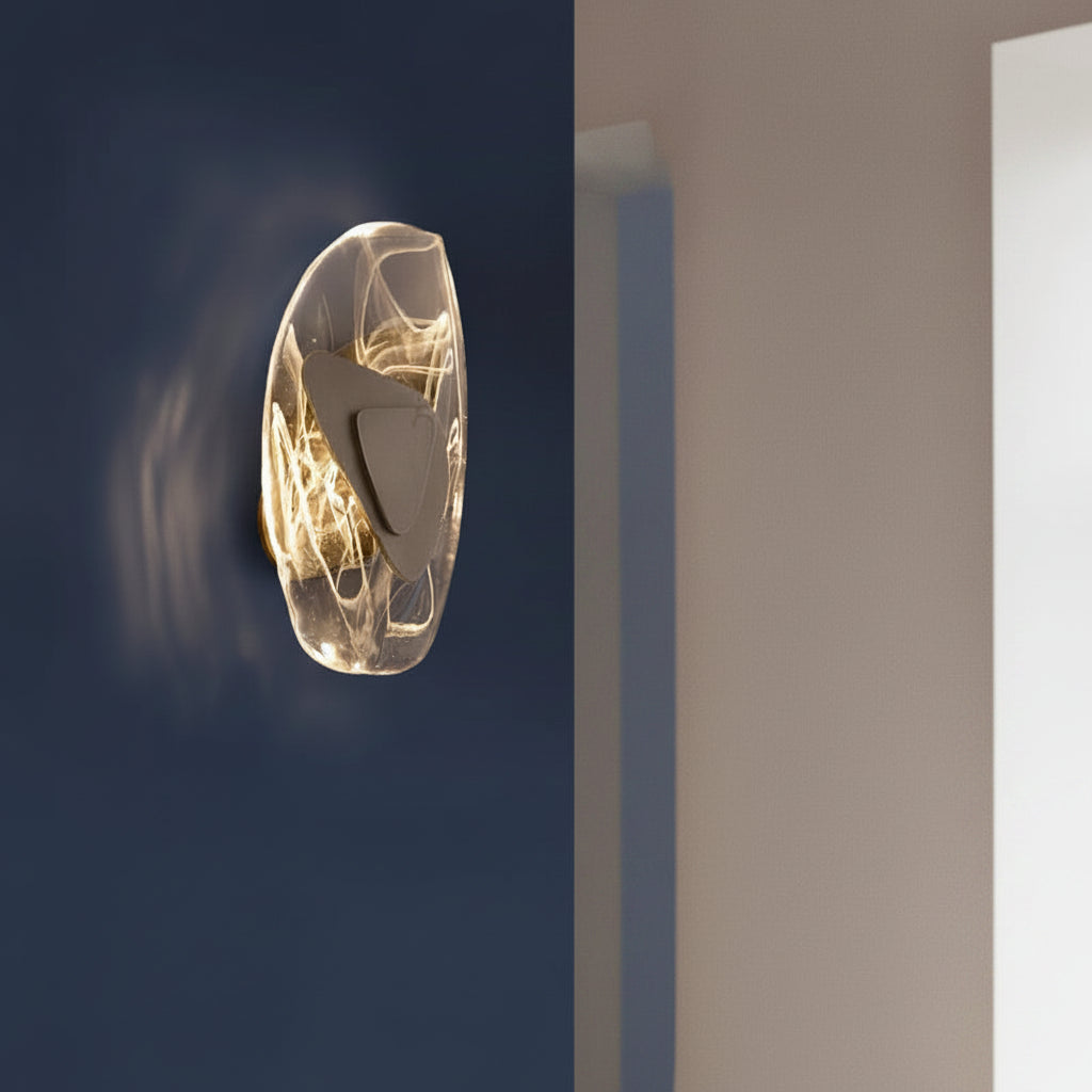 Layered egg wall light with translucent outer shell and black inner shade, warm glow.