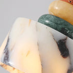 Close-up of marble-look pendant shade with black veining on a cream base